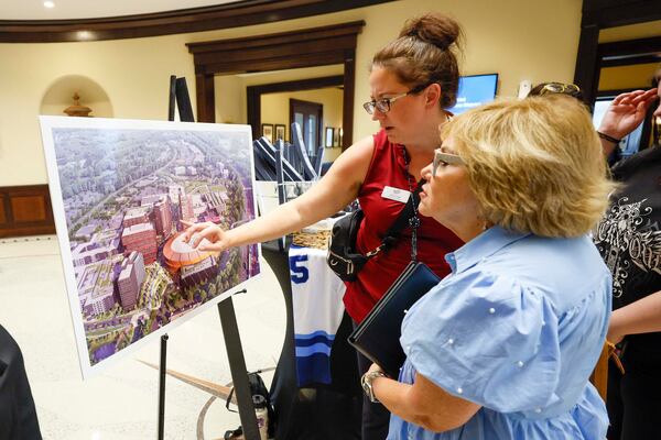 A rendering of the redevelopment design for North Point Mall is inspected before a recent public hearing. (Miguel Martinez/AJC)
