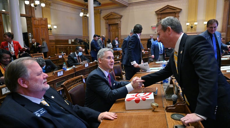 November 19, 2021 Atlanta - Sen. John Kennedy (R-Macon), center, is congratulated by John Albers (R-Roswell) after SB 2 EX, newly-drawn congressional maps, passed in the Senate Chambers during a special session at the Georgia State Capitol in Atlanta on Friday, November 19, 2021. (Hyosub Shin / Hyosub.Shin@ajc.com)