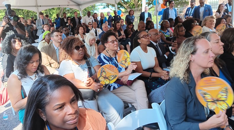 A crowd gathered under a tent outside the Oak Hill Child, Family & Adolescent Center at 2805 Metropolitan Parkway SW for the Aug. 8, 2024, ribbon-cutting on a new public behavioral health crisis center.