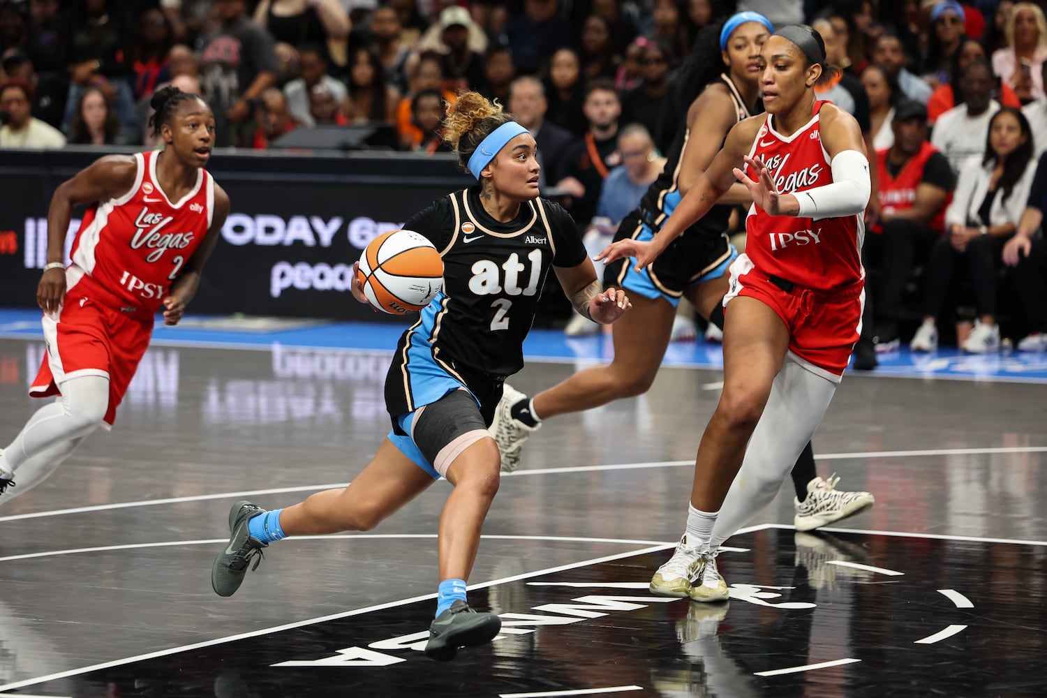 Atlanta Dream guard Te-Hina Paopao (2) drives to the basket against Las Vegas Aces center A'ja Wilson, right, during the second half of a WNBA game at State Farm Arena on Sunday, May 17, 2026, in Atlanta. (Colin Hubbard for the AJC) 