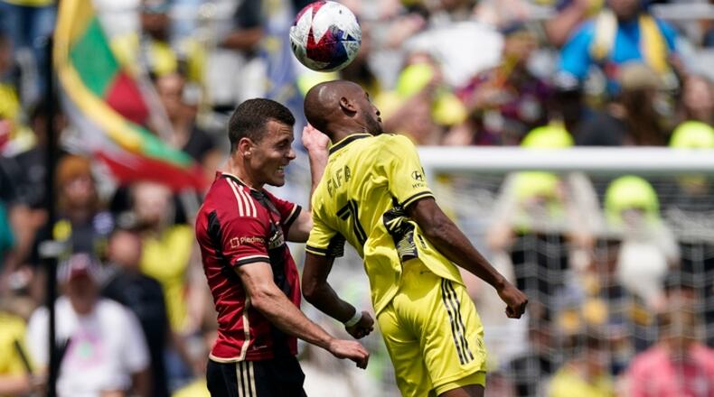 Nashville SC midfielder Fafà Picault (7) heads the ball past Atlanta United defender Brooks Lennon (11) during the first half of an MLS soccer match on Saturday, April 29, 2023, in Nashville, Tenn. (AP Photo/George Walker IV)