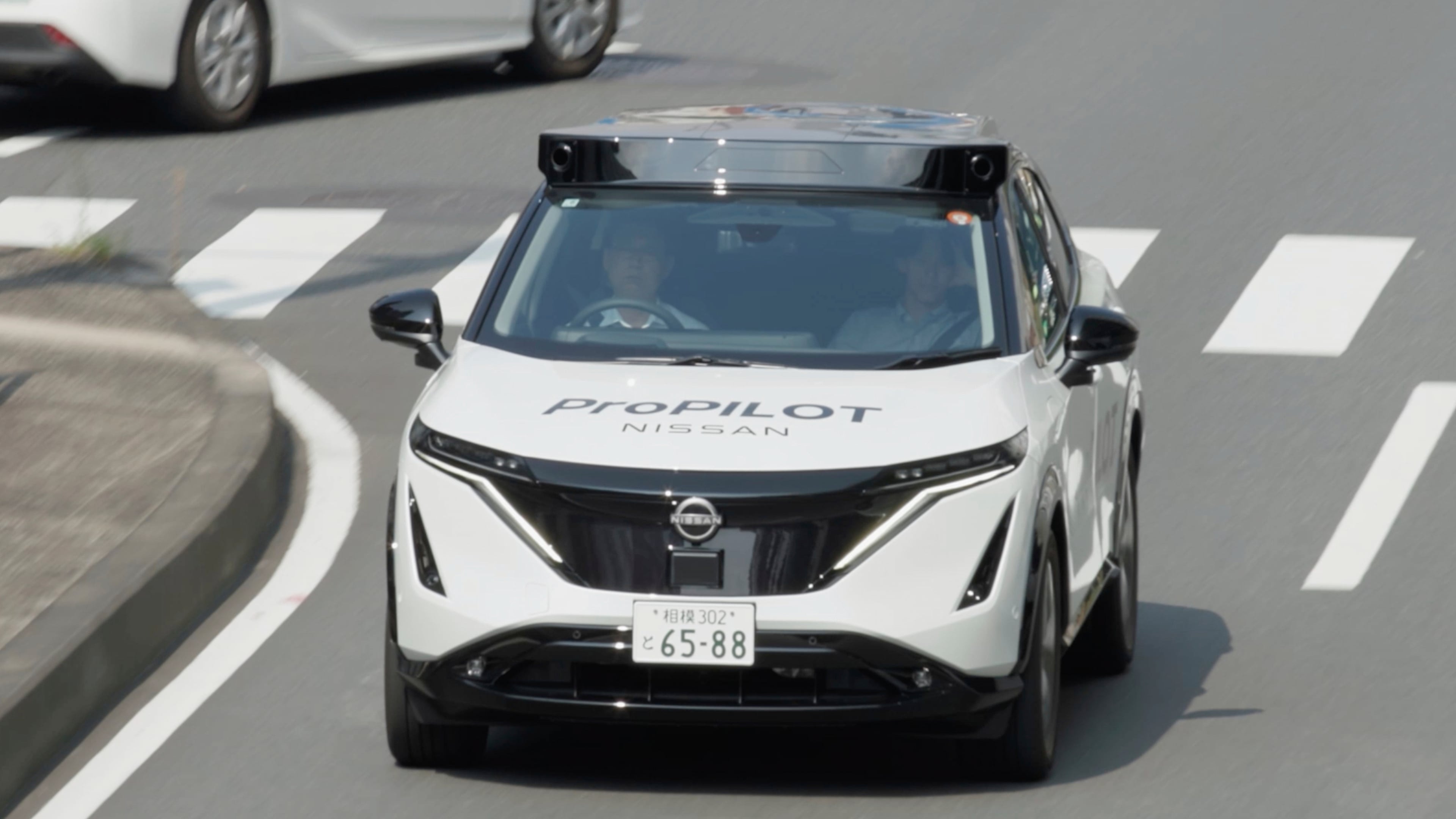 In this image made from video provided by Nissan Motor Co., Japanese automaker Nissan's test vehicle featuring an automated driving system packed with artificial intelligence moves on a road in Tokyo on September, 2025. (Nissan Motor Co. via AP)