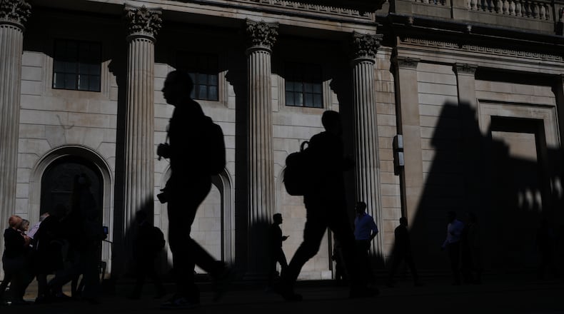 Pedestrians walk past the Bank of England in London, Thursday, April 30, 2026 as the Bank is expected announce in a press conference later to keep interest rates on hold. (AP Photo/Kirsty Wigglesworth)