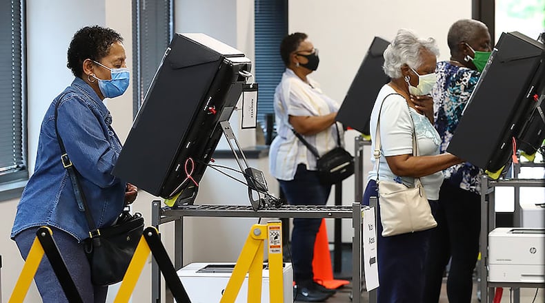 051820 Marietta: Voters wear masks and cast their ballots at least six feet apart the first day of early voting at the Cobb County Board of Elections & Registration on Monday afternoon, May 18, 2020, in Marietta.