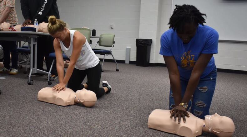Students at McClure Health Science High School practice CPR on specially designed mannequins. The school opened this fall and has invited to public for a tour on Sunday, Sept. 29. COURTESY OF GWINNETT COUNTY PUBLIC SCHOOLS