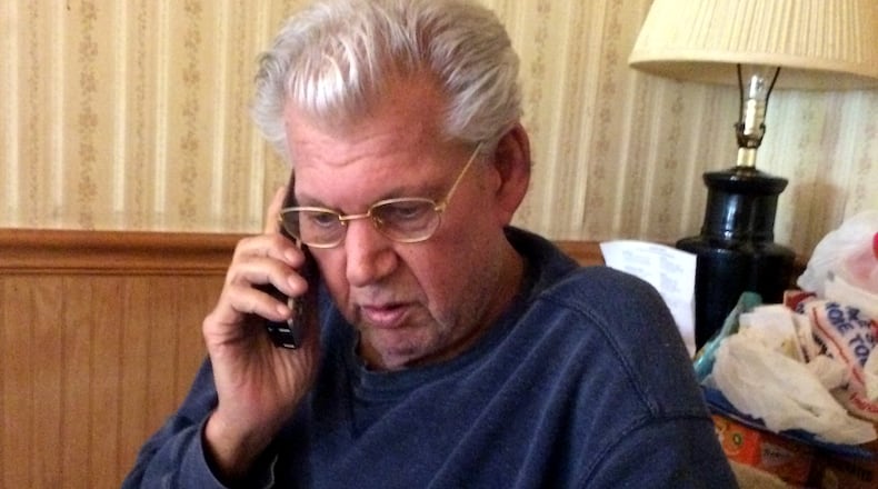 Robert Stackowitz talks on the phone at his kitchen table shortly after his release from custody in Connecticut. He was awaiting the outcome of Georgia's effort to bring him back here to serve out his sentence.