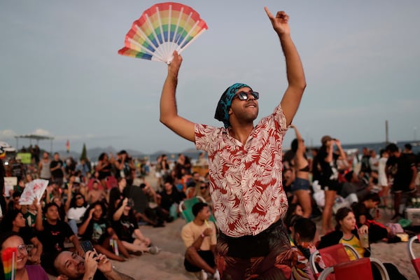 A fan cheers while waiting for the start of Lady Gaga's free concert on Copacabana beach in Rio de Janeiro, Saturday, May 3, 2025. (AP Photo/Bruna Prado)