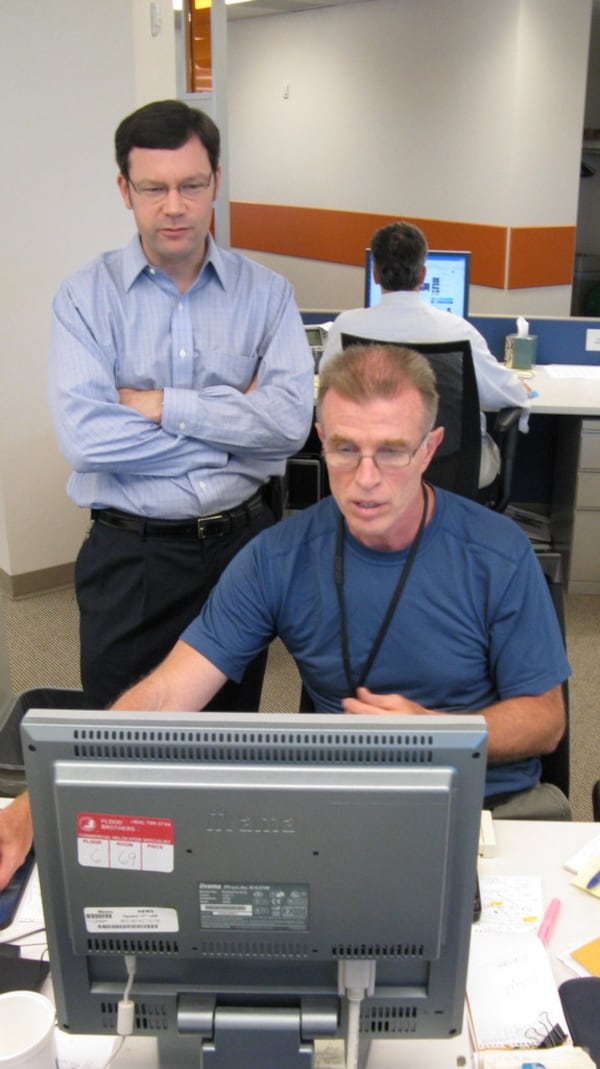 Then-editor Charlie Gay (standing) oversees changes on deadline. "I got along great with Charlie, except he kept insisting I stick 'nut grafs,' paragraphs that sum up a story, into each yarn," Bill Torpy says. (AJC file)