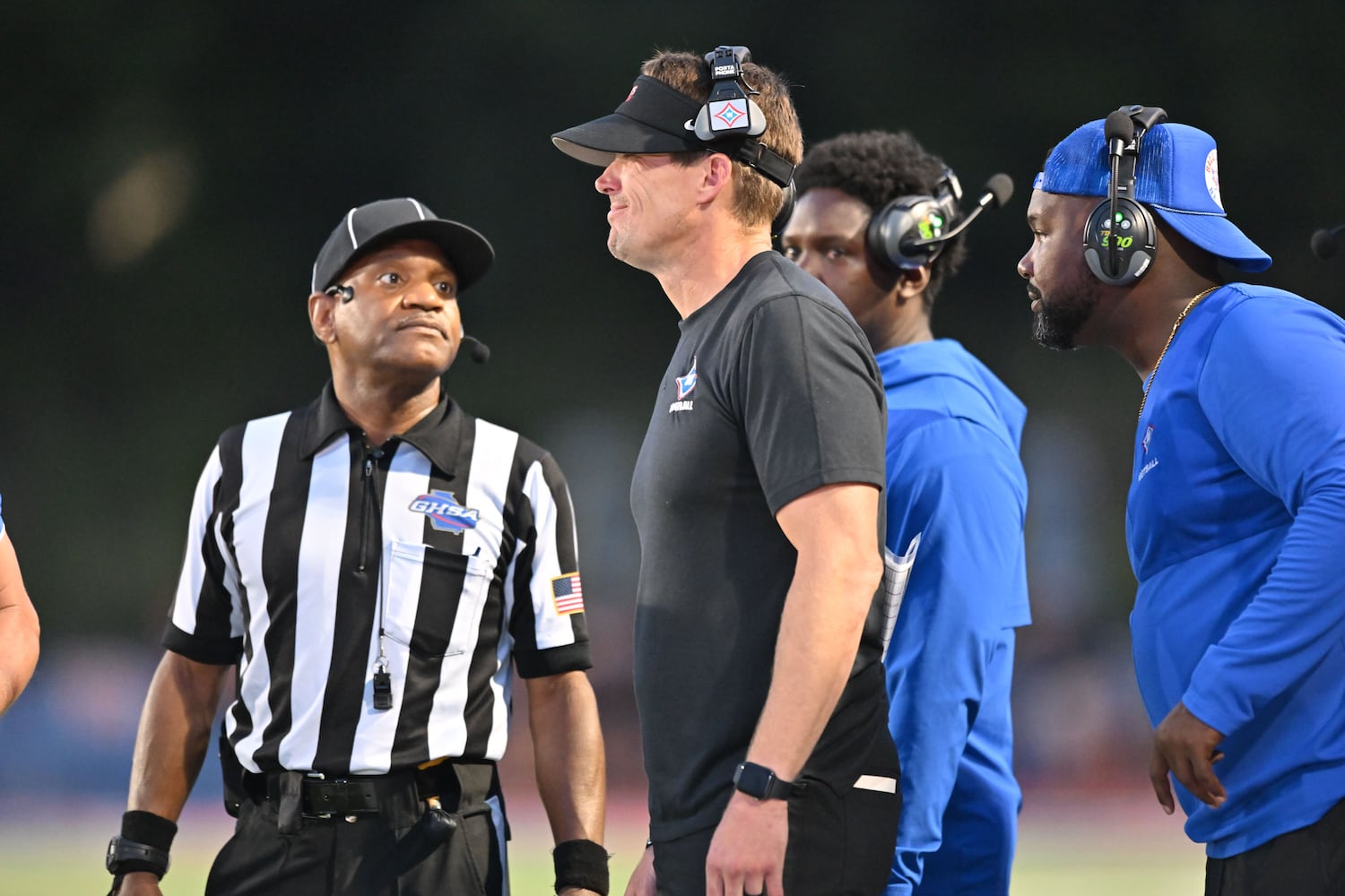 Walton head coach Jonathan Thompson (center) talks with a referee during the first half of a game Friday, August 29, 2025 at Walton High School. (Daniel Varnado/For the Atlanta Journal-Constitution)