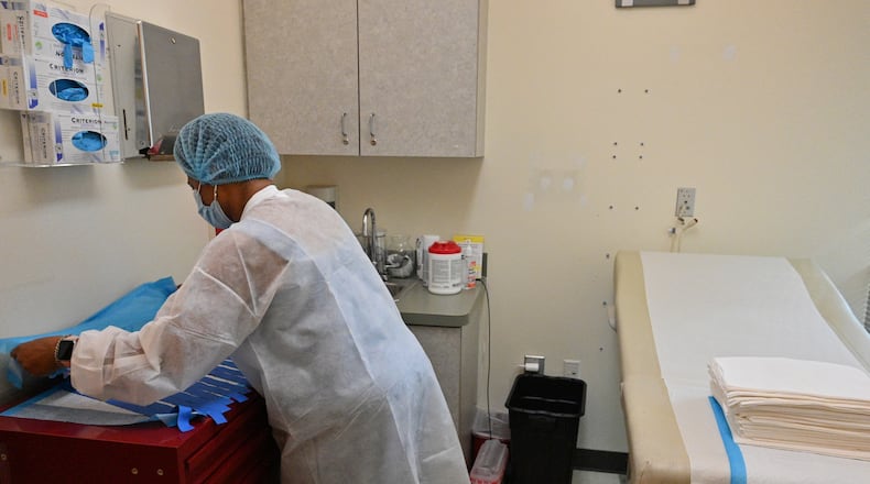 A member of the staff at the Feminist Women's Health Center prepares an examination room for a patient. A survey shows medical students would be less likely to apply for residency in states such as Georgia with restrictive abortion laws, with obstetrician-gynecologists being even more unlikely. As of 2020, 82 of Georgia’s 159 counties have no OB/GYNs, while an additional 15 only have one.
Georgia also consistently ranks among the states with the worst maternal mortality rates in the nation, indicating a need for more OB-GYNs. (Hyosub Shin / Hyosub.Shin@ajc.com)