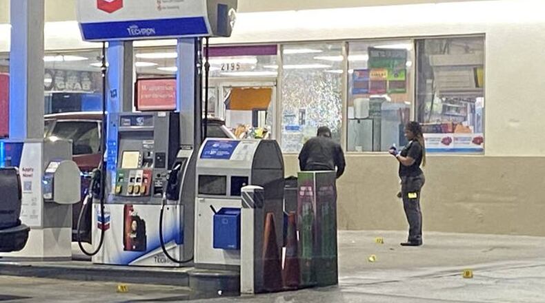 Two men were arrested after a bystander was shot at a Chevron in north Atlanta.