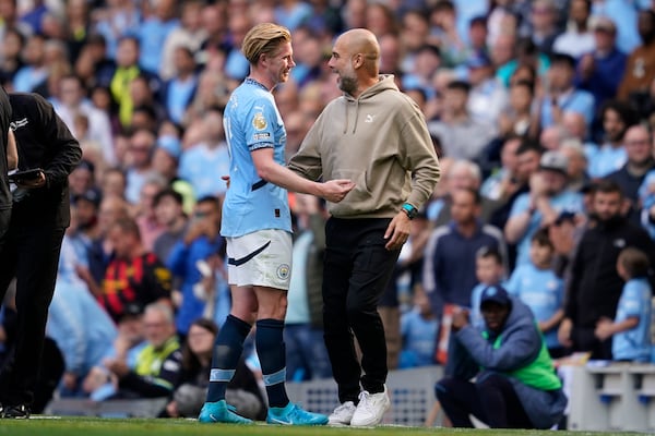 FILE - Manchester City's head coach Pep Guardiola talks with Kevin De Bruyne after being substitute during the English Premier League soccer match between Manchester City and Ipswich Town at the Etihad Stadium in Manchester, England, Saturday, Aug. 24, 2024. (AP Photo/Dave Thompson, file)