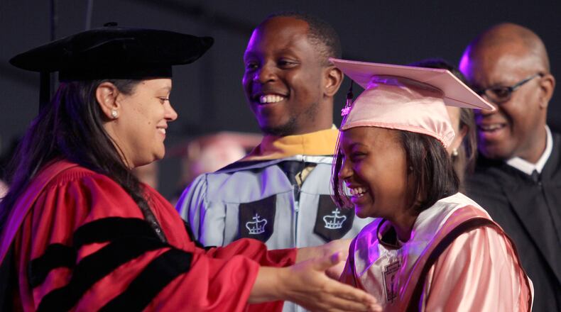 Atlanta Public School Superintendent Meria Carstarphen offers a hug to a student as she receives her diploma at the 2015 commencement ceremony for the Coretta Scott King Young Women's Academy High School and The Business Engineering Science and Technology (BEST) Academy at Benjamin S. Carson.  (Akili-Casundria Ramsess/Special to the AJC)