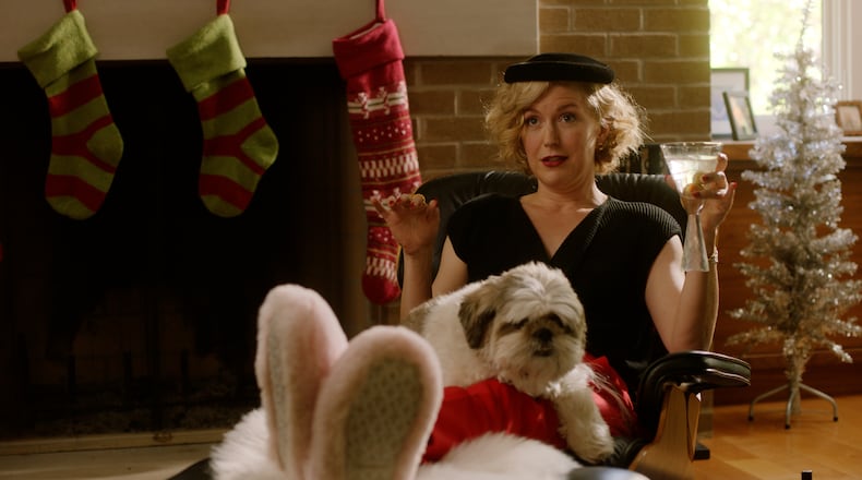 “Christmas with Jerks” writer, co-director and lead actor Leanna Adams in a scene with Mickey the dog.