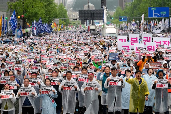 Members of the Korean Confederation of Trade Unions gather to attend a rally on May Day in Seoul, South Korea, Thursday, May 1, 2025. The letters read "Let's win basic labor rights." (AP Photo/Ahn Young-joon)