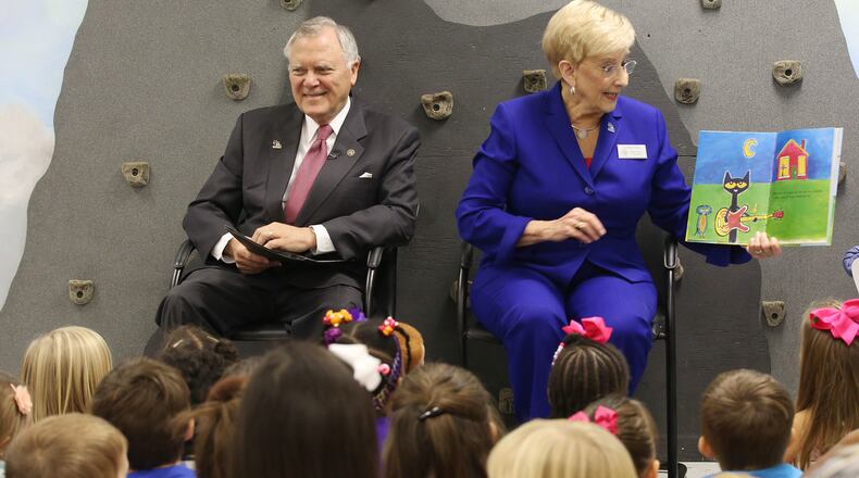 Gov. Nathan Deal, shown here with his wife, Sandra reading at a metro school, is increasing efforts to win public support of his Opportunity School District, which is on the ballot in November.