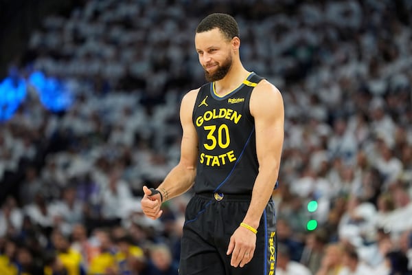 Golden State Warriors guard Stephen Curry (30) gestures during the first half of Game 1 of an NBA basketball second-round playoff series against the Minnesota Timberwolves, Tuesday, May 6, 2025, in Minneapolis. (AP Photo/Abbie Parr)