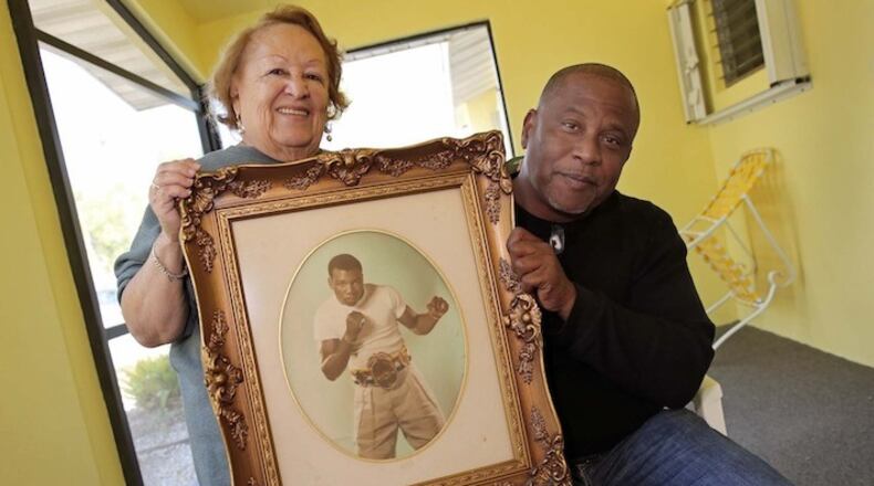 Luz Selenia Paret, wife of Champion cuban boxer Benny "Kid" Paret, along with her son Benny Paret Jr., at her home in southwest Dade County, Fla. (C.M. Guerrero/El Nuevo Herald/TNS)
