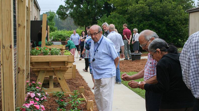Visitors to the Sexton Hall in Cumming check out the Live Well Garden, a newly planted community garden. FORSYTH COUNTY