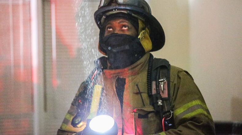 A family's new home caught fire early Tuesday in DeKalb County. JOHN SPINK / JSPINK@AJC.COM