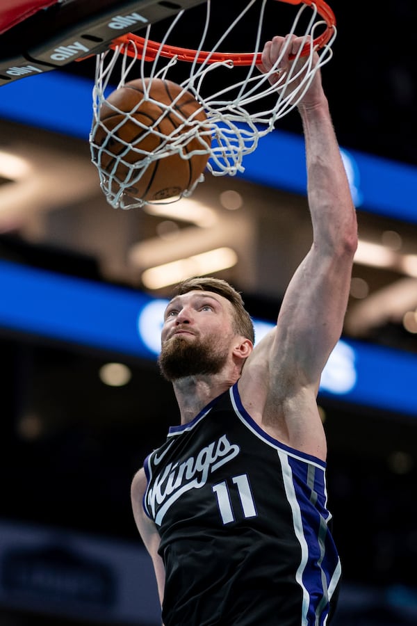Sacramento Kings forward Domantas Sabonis dunks during the second half of an NBA basketball game against the Charlotte Hornets, Friday, April 4, 2025, in Charlotte, N.C. (AP Photo/Jacob Kupferman)