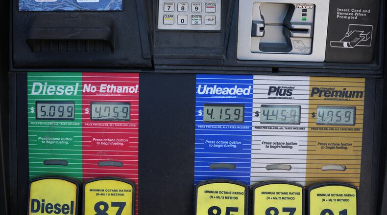 The per-gallon price is displayed electronically over the various grades of fuel available from a pump at a QT gasoline station Thursday, July 30, 2026, in Greenwood Village, Colo. (AP Photo/David Zalubowski)