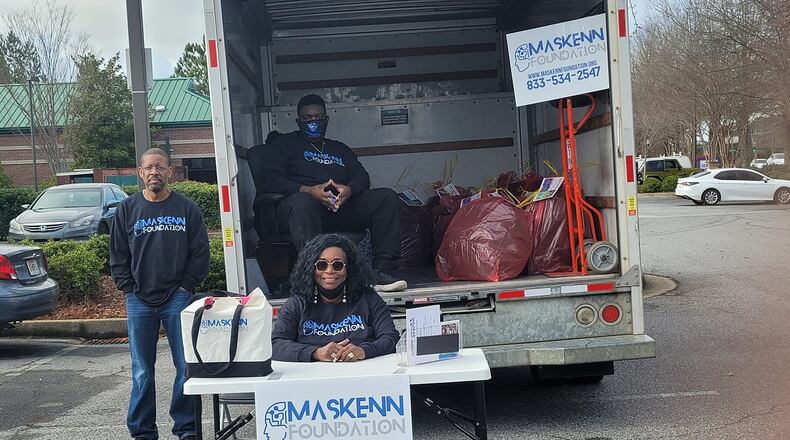 The Alpharetta-based MasKenn Foundation is hoping to excite local students about future careers in Science, Technology, Engineering, Math and Mental Health (STEAMM). Here, Kennedy family members (l-r) Warren Kennedy, Kyra Massey Kennedy and Kyren Kennedy are collecting donations for their annual toy drive. (Courtesy MasKenn Foundation)