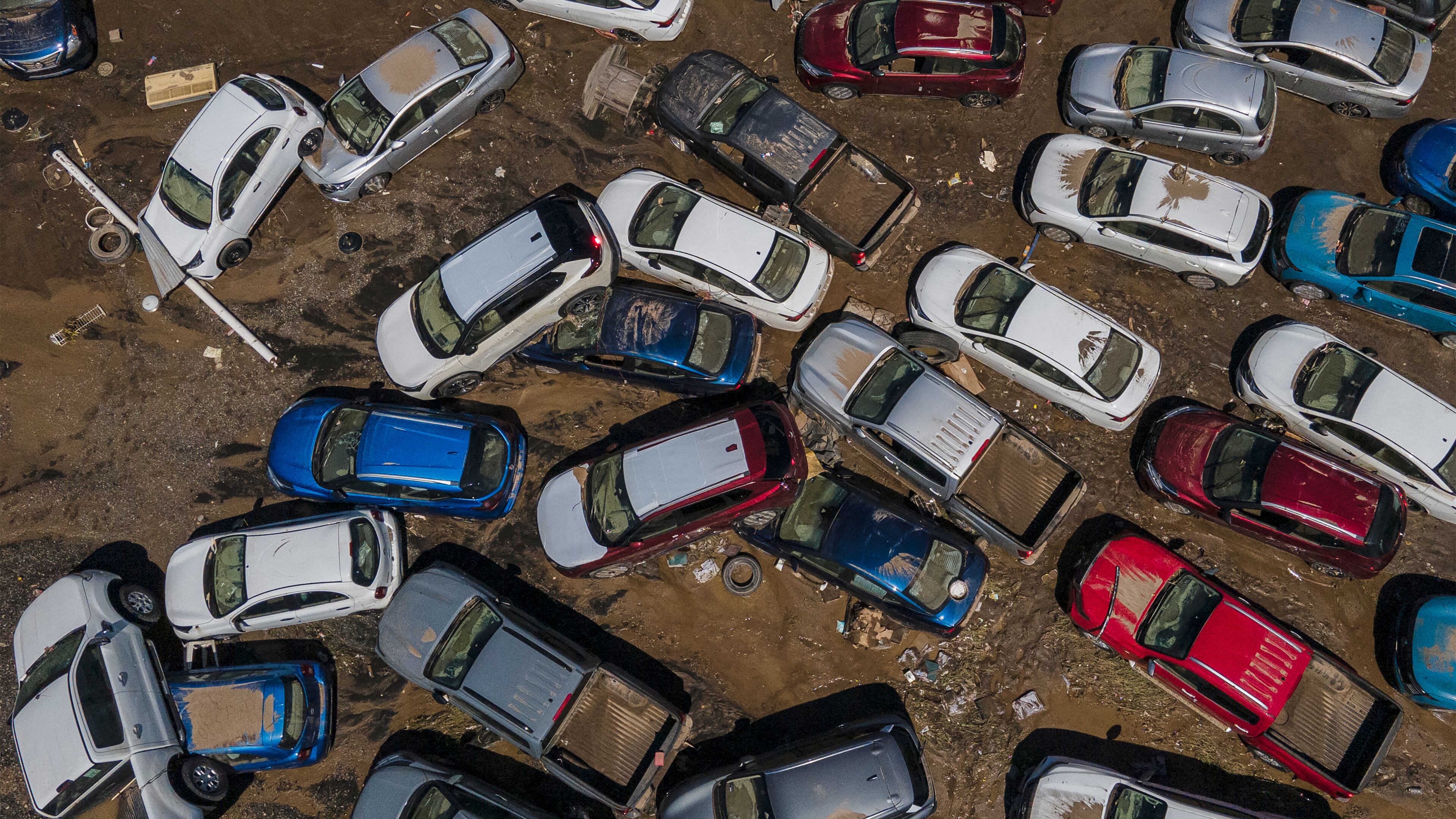 Damaged vehicles sit in mud after flooding in Poza Rica, Veracruz state, Mexico, Sunday, Oct. 12, 2025. (AP Photo/Felix Marquez)