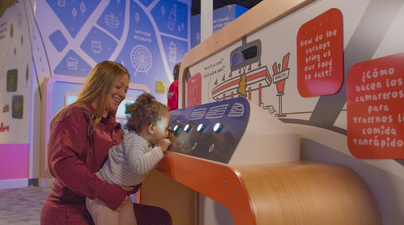 A young child gets a lift at the Goizueta Children’s Experience at the Atlanta History Center. Courtesy of Atlanta History Center