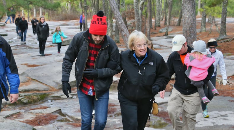 WALKING THE MOUNTAIN--Dec. 31, 2013 - Stone Mountain - Benito Ferro (left) and Margie Bowen walk together on the hike. Ferro is Bowen's daughter's boyfriend. On Tuesday morning, 63-year-old Margie Bowen hiked up Stone Mountain for the 500th time (all since mid-2010). Her daughter and her daughter's boyfriend wanted to mark the occasion on Instagram, by creating an "instawalk". Bowen's friends and former students will joined her on the walk and documented the climb on Instagram with dozens of photos. BOB ANDRES / BANDRES@AJC.COM