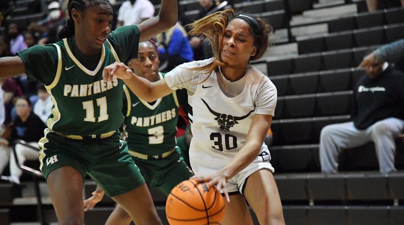 February 25, 2022 Marietta - Kell’s Crystal Henderson (30) drives against Langston Hughes' Sydney Smith (11) in the second half of 2022 Georgia Girls State Basketball playoffs at Kell high school in Marietta on Friday, February 25, 2022. Kell won 57-50 over Langston Hughes. (Hyosub Shin / Hyosub.Shin@ajc.com)