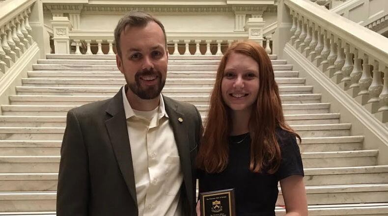 Riverwood International Charter School Principal Charles Gardner (left) stood with his student Dori Balser on the interior steps of the Georgia State Capitol after Balser received the 2017 Woodrow Wilson Community Service award from the Princeton Club in recognition of her outstanding service to her community.