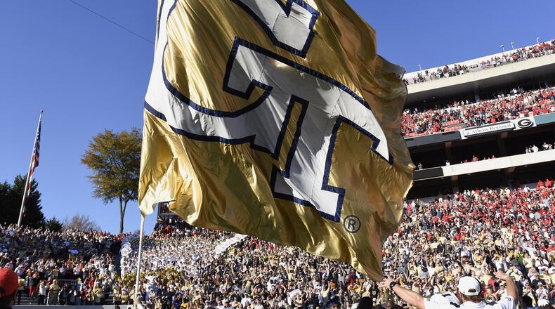 Georgia Tech's flag is waved after the conclusion of the NCAA college football game between the University of Georgia and Georgia Tech in Athens, Georgia, on Saturday, November 26, 2016. Tech beat UGA 28-27. (DAVID BARNES / DAVID.BARNES@AJC.COM)