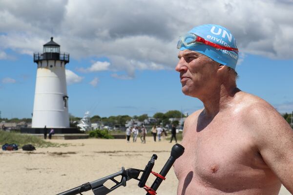 British South African endurance swimmer Lewis Pugh speaks with press directly after completing his 12-day 62-mile (100 kilometer) swim around the island of Martha's Vineyard, Mass., ahead of the 50th anniversary of the first blockbuster film "Jaws"' release, Monday, May 26, 2025. (AP Photo/Leah Willingham)