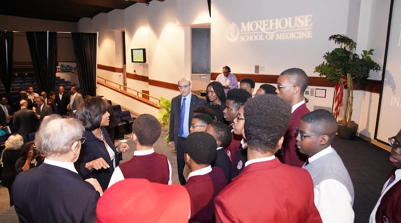 Morehouse School of Medicine president Dr. Valerie Montgomery Rice, wearing black blazer, and 2008 Nobel Prize winner Dr. Martin Chalfie, wearing blue tie, speak with students from Fulton Leadership Academy, who heard his lecture on Tuesday, March 27, 2018. PHOTO CONTRIBUTED