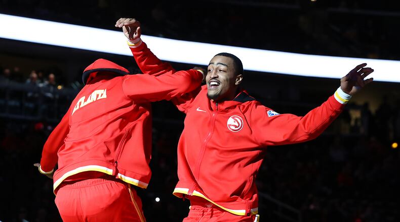 Hawks Clint Capela (left) and John Collins take the court to play the Houston Rockets in a NBA basketball game on Monday, Dec 13, 2021, in Atlanta.   “Curtis Compton / Curtis.Compton@ajc.com”`
