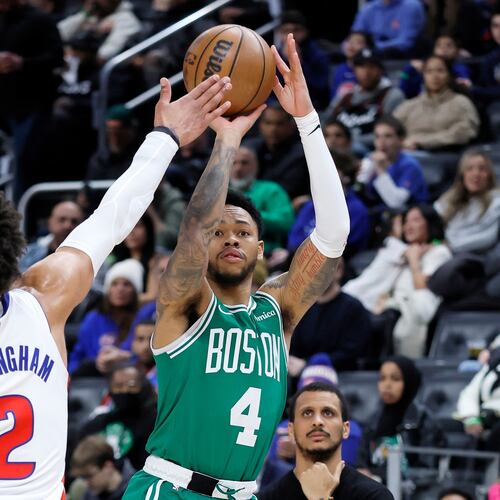 Boston Celtics guard Anfernee Simons (4) takes a shot against Detroit Pistons guard Cade Cunningham (2) during the first half of an NBA basketball game Monday, Jan. 19, 2026, in Detroit. (AP Photo/Duane Burleson)