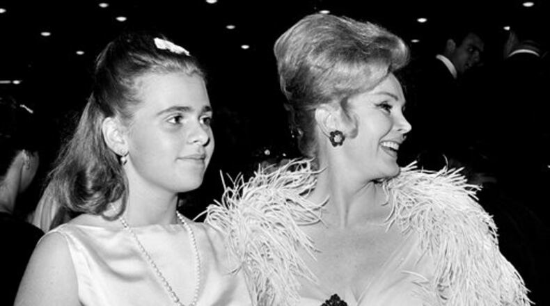 FILE-This June 20, 1963 file photo Zsa Zsa Gabor, right, and her 16-year-old daughter Francesca Hilton are seen arriving for a premiere in the Hollywood. Publicist Edward Lozzi says Hilton died Monday, Jan. 5, 2015 at Cedars-Sinai Medical Center after an apparent heart attack and stroke. She was 67. (AP Photo/Harold P. Matosian, File)