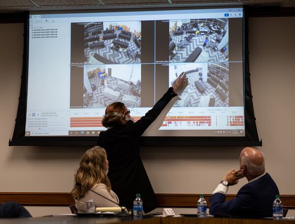 201203-Atlanta- Jacki Pick points out what she considered suspicious activity on surveillance video of the Fulton County absentee vote counting room as she and Rudy Giuliani address a subcommittee of the state Senate judiciary committee at the State Capitol on Thursday, Dec. 3, 2020. Ben Gray for the Atlanta Journal-Constitution