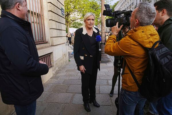 FILE - French far-right leader Marine Le Pen answers to the media during a gathering in support of detained Franco-Algerian writer Boualem Sansal, in Paris, Tuesday, March 25, 2025. (AP Photo/Thibault Camus, File)
