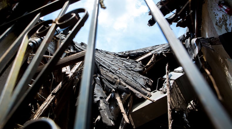 The caved in roof is seen through a barred window at the childhood home of former Atlanta mayor Maynard Jackson at 220 Sunset Avenue NW in Atlanta, Ga., on Tuesday, May 7, 2019. The home, which has fallen into disrepair, is set to be demolished. (Casey Sykes for The Atlanta Journal-Constitution)