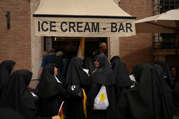 Nuns enter an ice cream coffee bar near the Vatican, in Rome, on Wednesday, May 7, 2025, on the day cardinals sequester themselves at the Vatican for the start of a conclave to elect the 267th Roman pontiff, a successor to Pope Francis. (AP Photo/Francisco Seco)