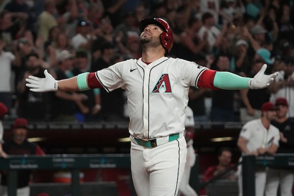 Arizona Diamondbacks' Eugenio Suárez reacts after hitting a solo home run and fourth of the game against the Atlanta Braves in the ninth inning during a baseball game, Saturday, April 26, 2025, in Phoenix. (AP Photo/Rick Scuteri)