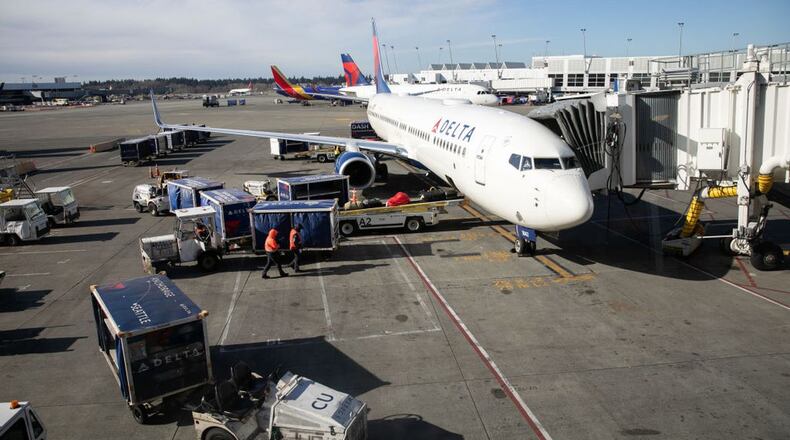 SEATTLE, WA - MARCH 15: A ground crew prepares to unload luggage from an arriving Delta Airlines flight at the Seattle-Tacoma International Airport on March 15, 2020 in Seattle, Washington. (Photo by John Moore/Getty Images) (John Moore/Getty Images)