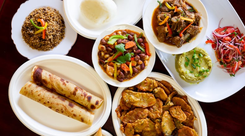 Jambo Grill offers traditional Kenyan dishes, including (clockwise from left) chapati, pilau, ugali, githeri, goat stew, kachumbari, irio, bhajias and beef samosa. Ryan Fleisher for The Atlanta Journal-Constitution