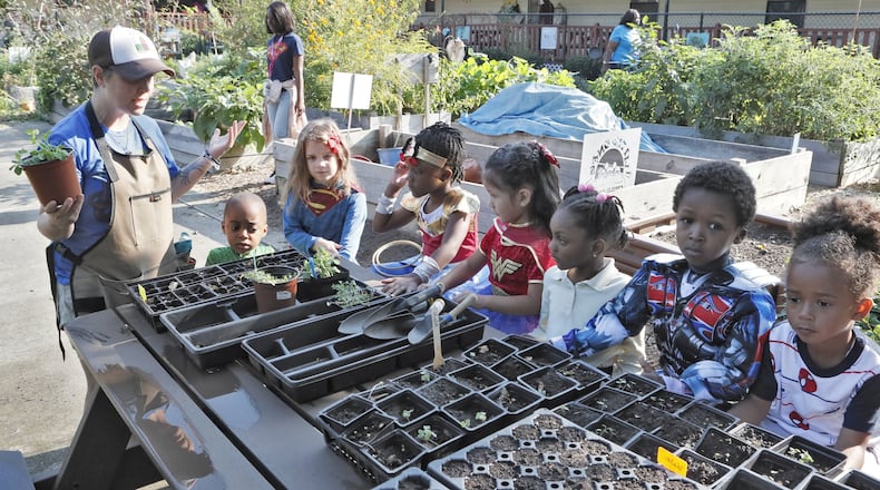 Germaine Appel, the garden educator at Little Ones Learning Center in Forest Park, teaches the kids about planting seeds on Sept. 11, 2019. Little Ones is one of 18 state farm to school demonstration projects: Students grow and harvest food, and the school sells it to their parents and to the surrounding neighborhood. However, the little school can no longer sell its produce, after the city said it violated local codes. The property isn’t zoned for farm stands.