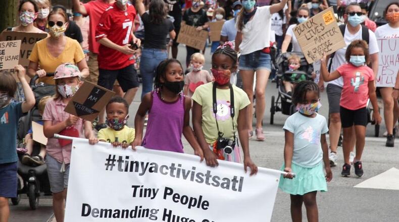 June 7, 2020 -  Atlanta - A protest group calling themselves the Tiny Activists marched to the Jackson Street bridge to lay flowers.  Demonstrations continued in Atlanta Sunday.   Protests over the death of George Floyd in Minneapolis police custody continued around the United States, as his case renewed anger about others involving African Americans, police and race relations.     Steve Schaefer for the Atlanta Journal Constitution