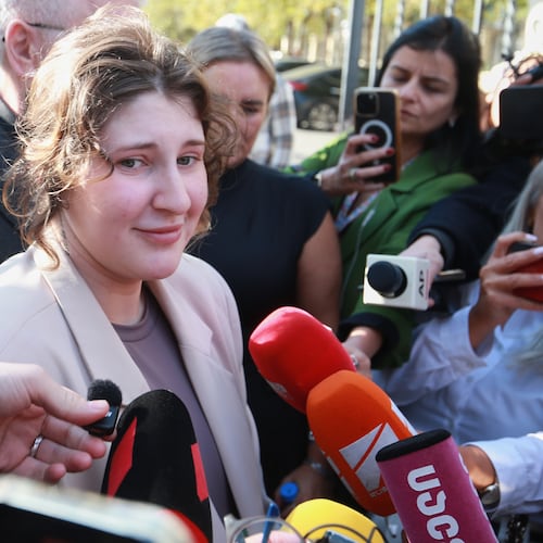 Bella May Culley, front left, 19-year-old, who was arrested upon arrival at the Tbilisi Airport in May and accused of attempting to smuggle marijuana and hashish into the country, speaks to journalists after she was released from prison near the court building in Tbilisi, Georgia, on Monday, Nov. 3, 2025, as her mother Lyanne Kennedy, stands behind. (AP Photo/Zurab Tsertsvadze)