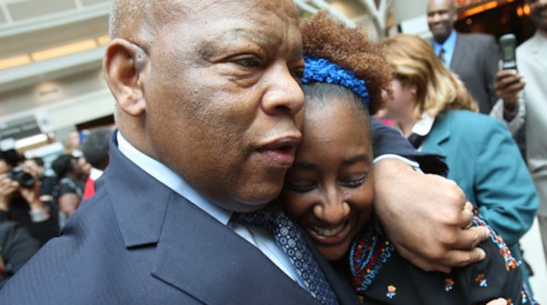 WARM WELCOME HOME--Congressman John Lewis returns to Atlanta with an unexpected welcome surprise at Hartsfield-Jackson International Airport Monday, Feb. 21, 2011. Author Dawn Loney Causey gets a hug from Congressman Lewis after she presented him her book, "Uncle Booker's Quilt" as a Birthday gift. Last week Rep. Lewis received the Presidential Medal of Freedom, the nation's highest civilian honor. "This is the best welcome," he said to a large crowd.