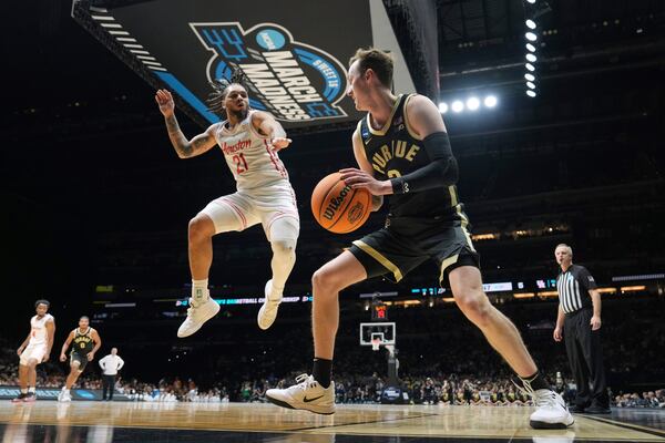 Purdue's Fletcher Loyer, right, looks to pass around Houston's Emanuel Sharp (21) during the first half in the Sweet 16 of the NCAA college basketball tournament Friday, March 28, 2025, in Indianapolis. (AP Photo/AJ Mast)